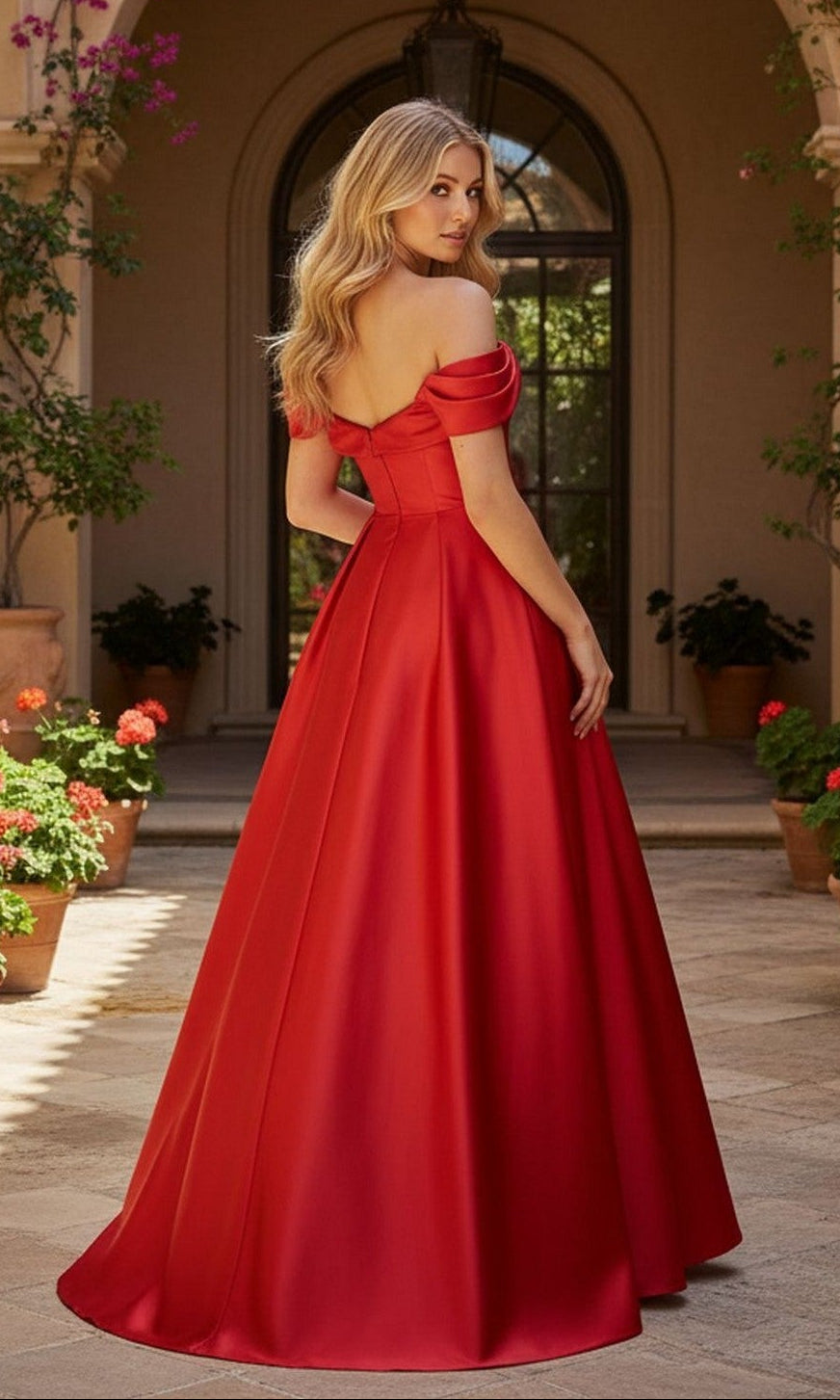 A woman with long blonde hair stands outside, facing away from the camera, wearing the Long Prom Dress: Blondie Nites 6019BN. Potted plants and an arched doorway are visible in the background.